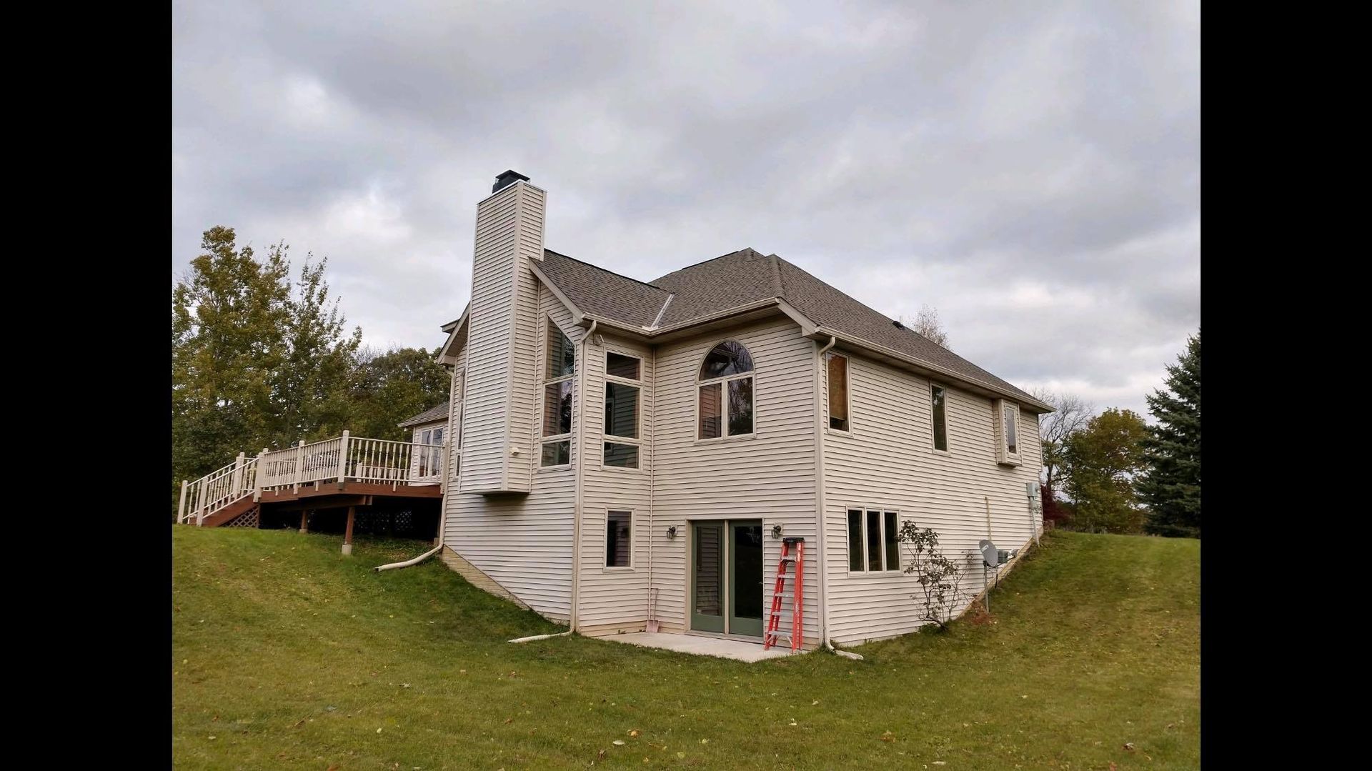 A large white house with a ladder in front of it.