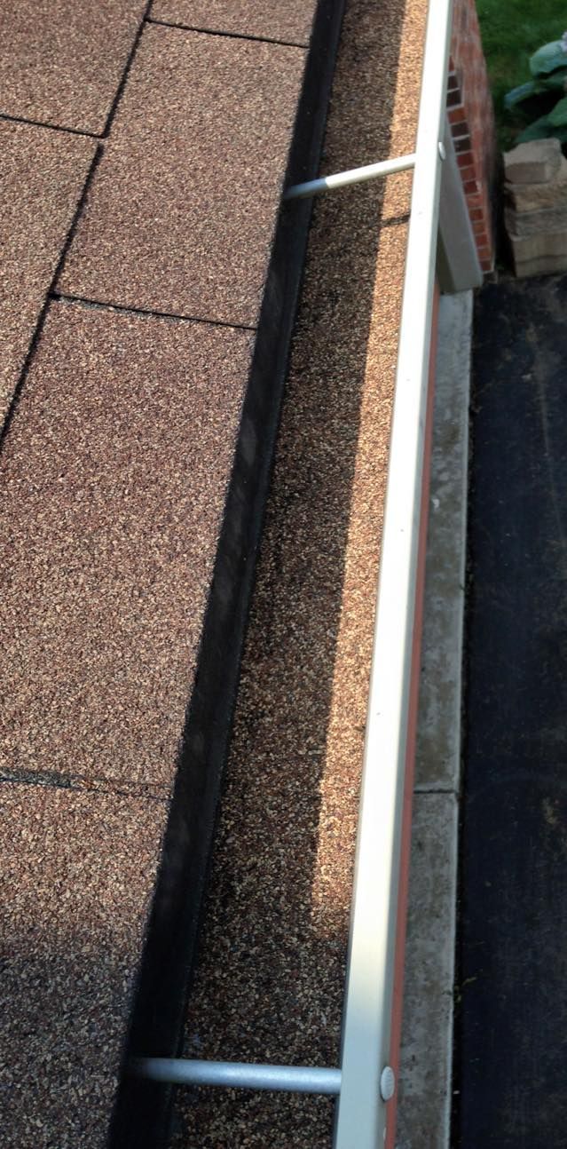 A close up of a gutter on the side of a building.