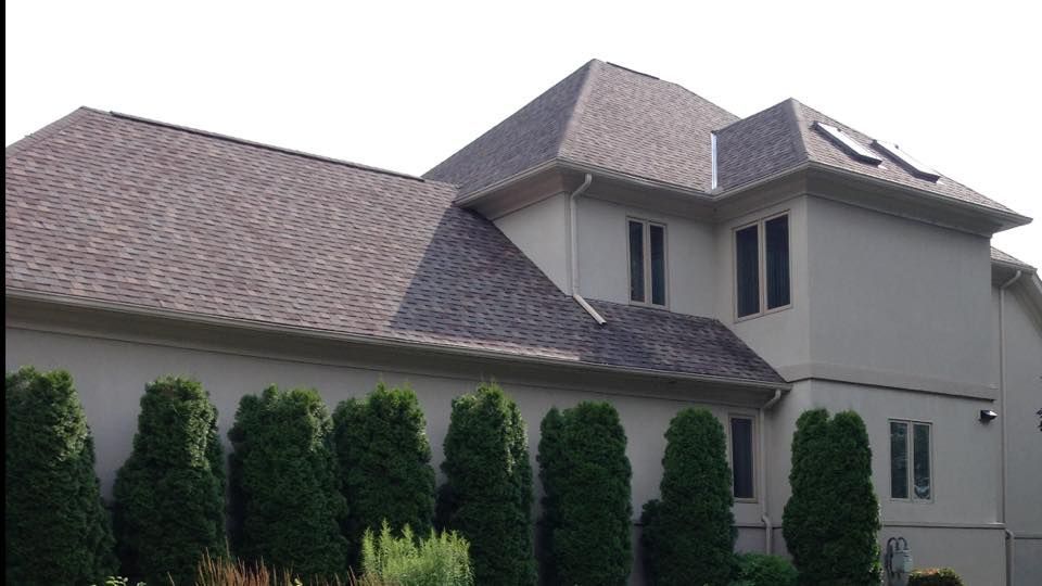 A large house with a roof that has a skylight on it