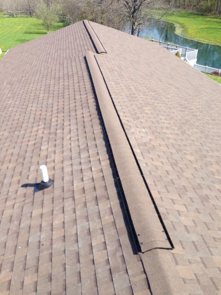 The roof of a house with a view of a lake