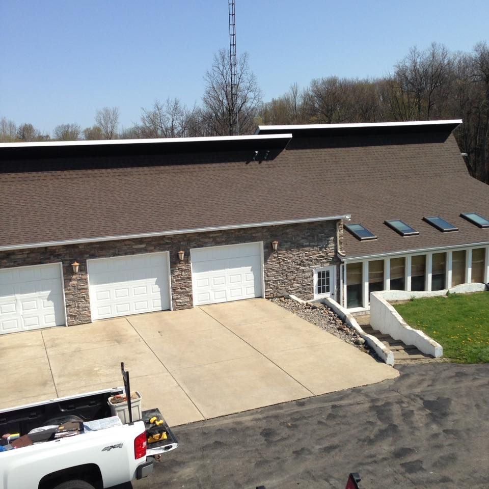 A white truck is parked in front of a house