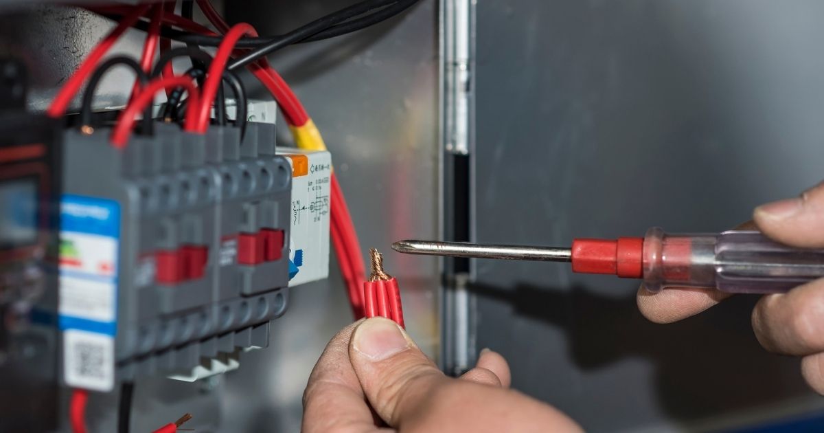 Electrician Repairing Electrical Systems In Busy Commercial Kitchen Sunshine Coast