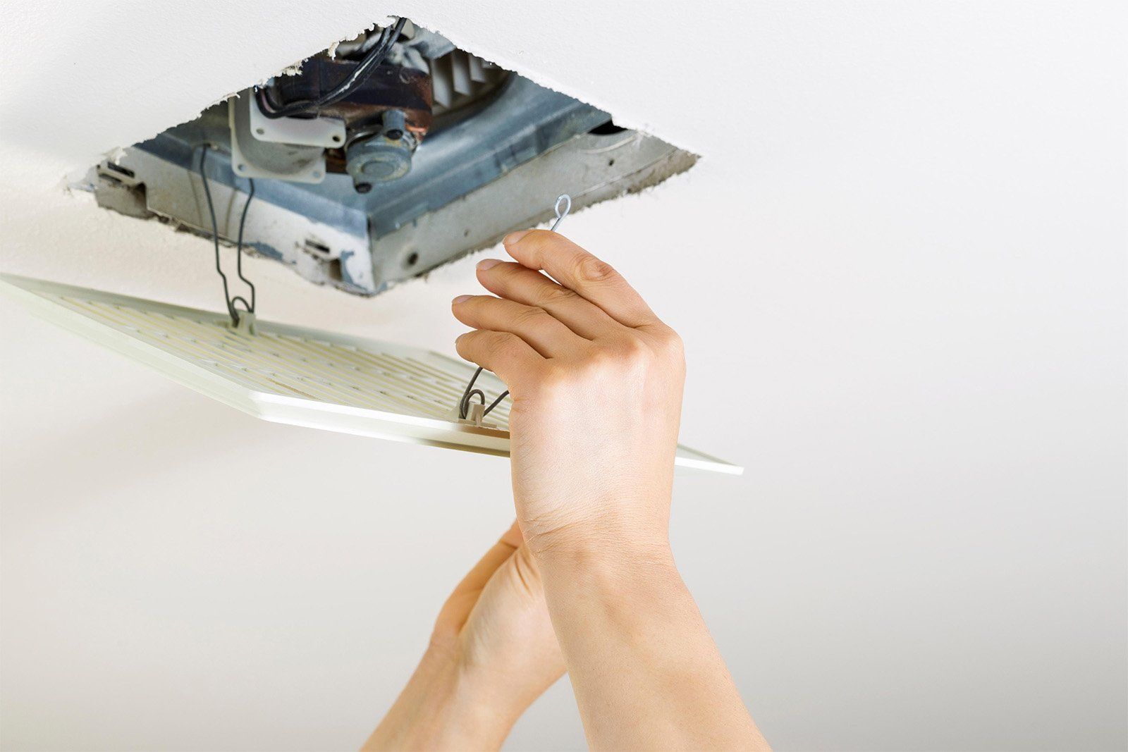 Sunshine Coast Electrician Installing An Exhaust Fan In A Bathroom