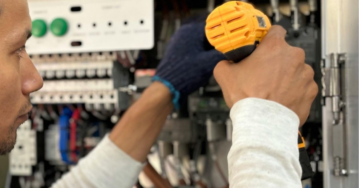 Electrician Repairing Commercial Switchboard For Local Business Owner Sunshine Coast