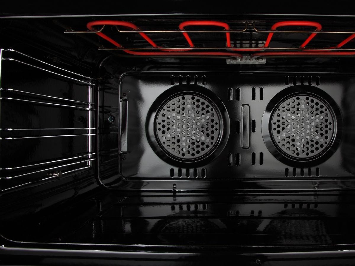 Electrician Repairing Wiring Issues Behind Oven In Sunshine Coast Home