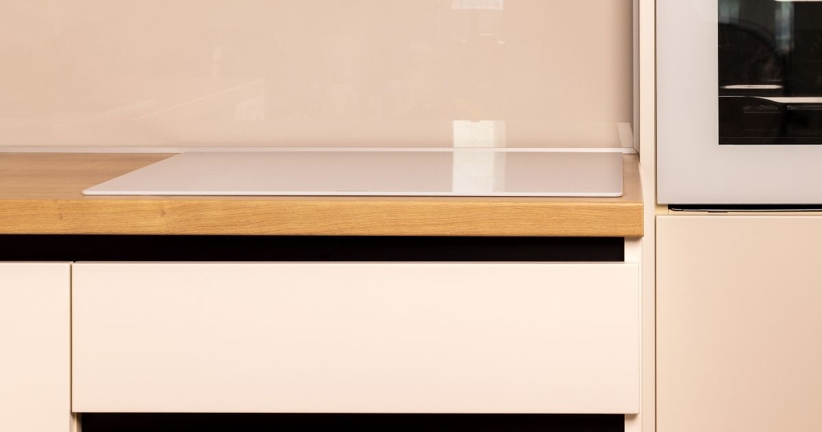 Electrician Performing Safety Check On Newly Installed Induction Cooktop Sunshine Coast