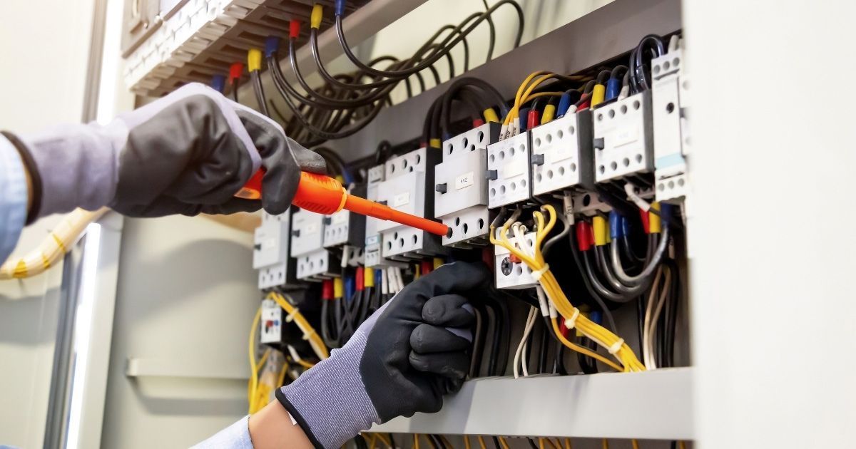 Licensed Electrician Replacing An Outdated Switchboard For Improved Safety Sunshine Coast