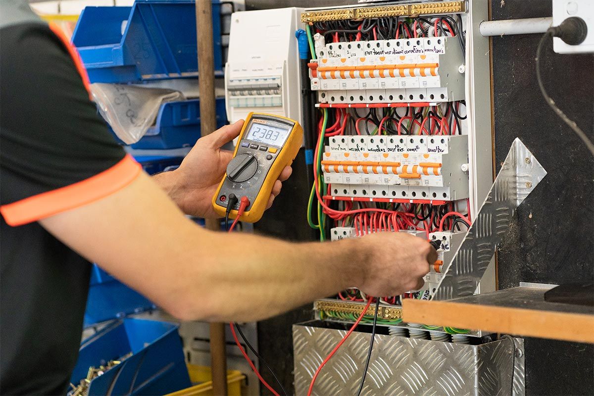 Local Caloundra Electrician Working On An Electrical Switchboard