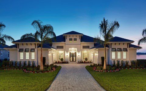 A large white house with palm trees in front of it