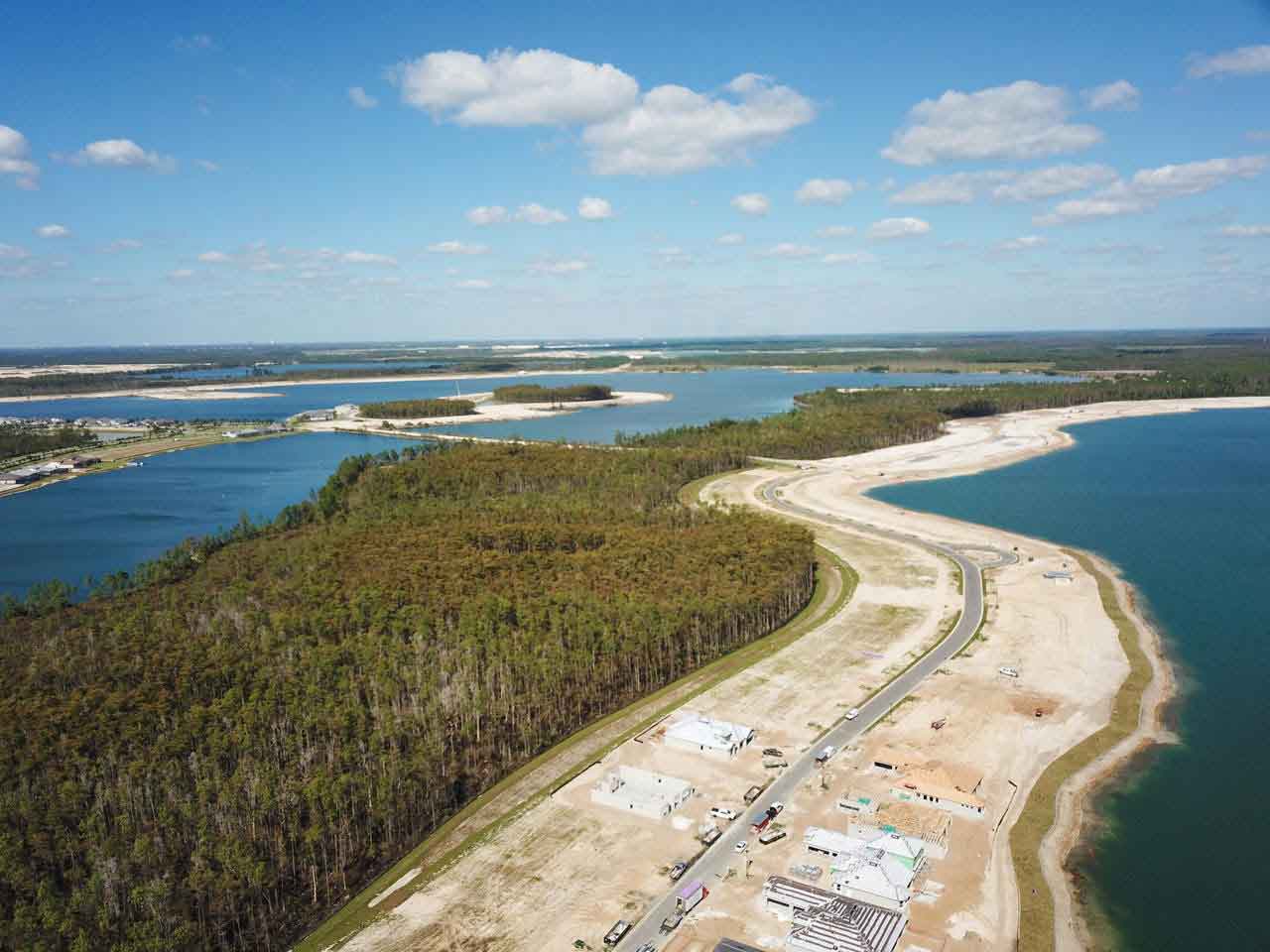 An aerial view of a large body of water surrounded by trees.