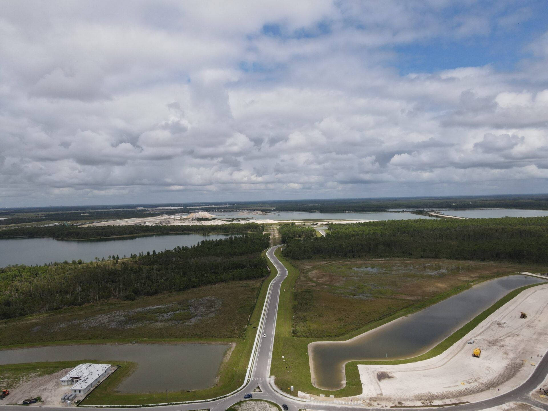 An aerial view of a lake and a road
