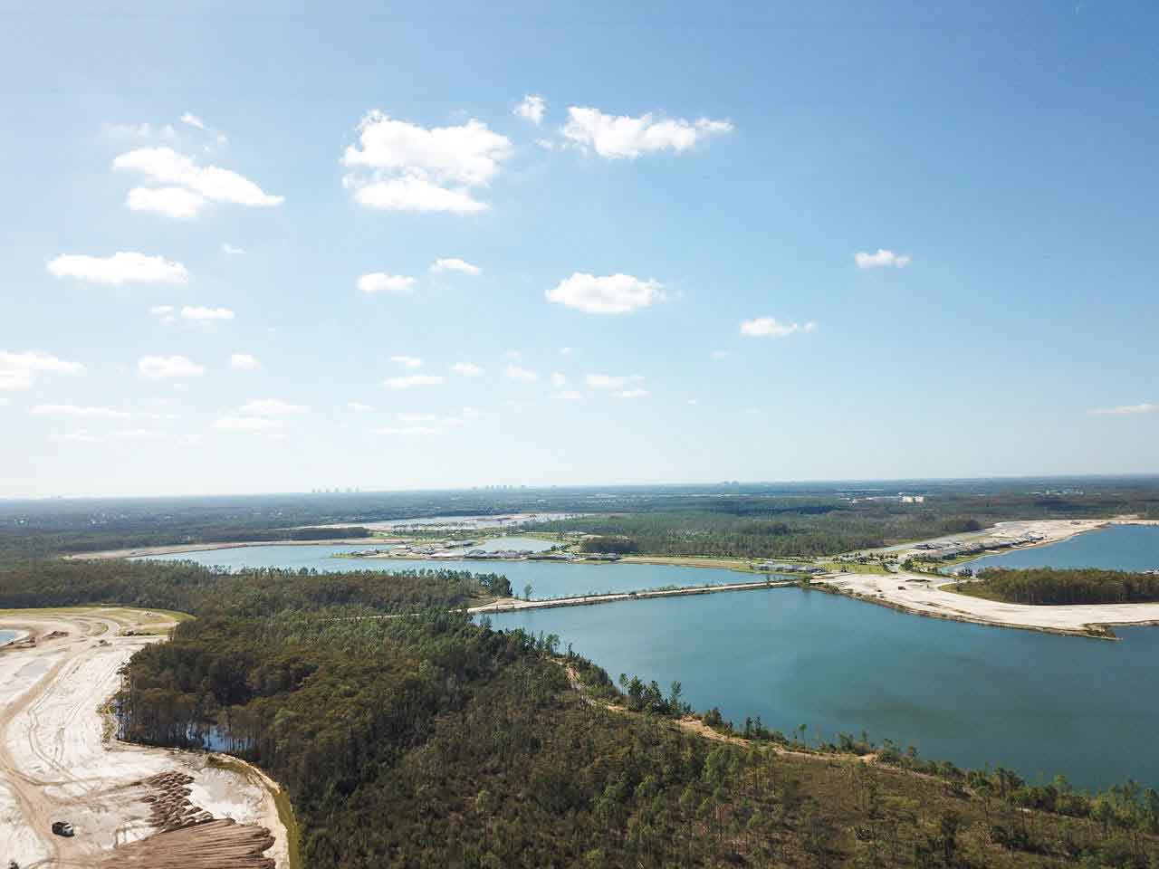 An aerial view of a large body of water surrounded by trees.