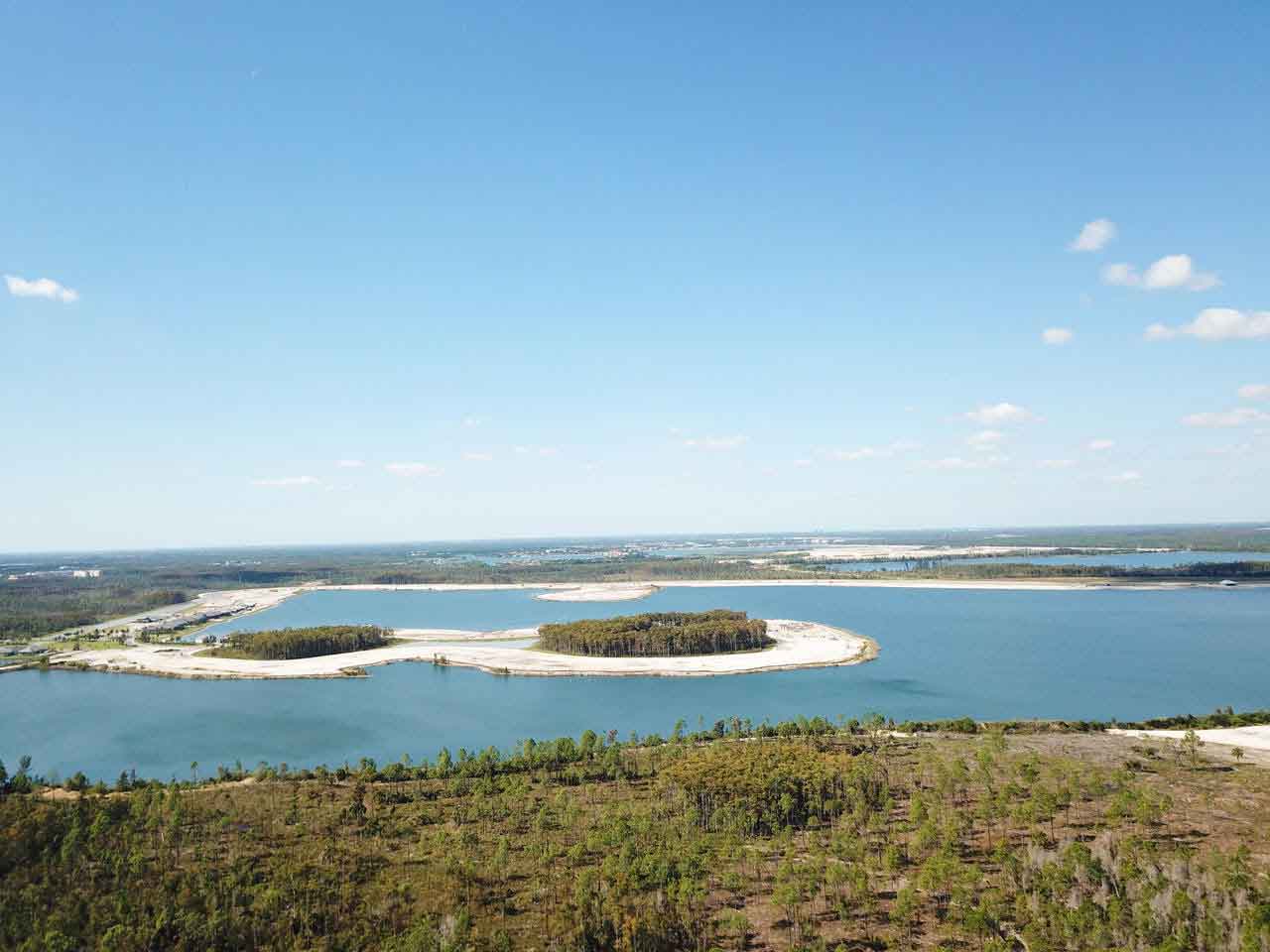 An aerial view of a large body of water surrounded by trees.