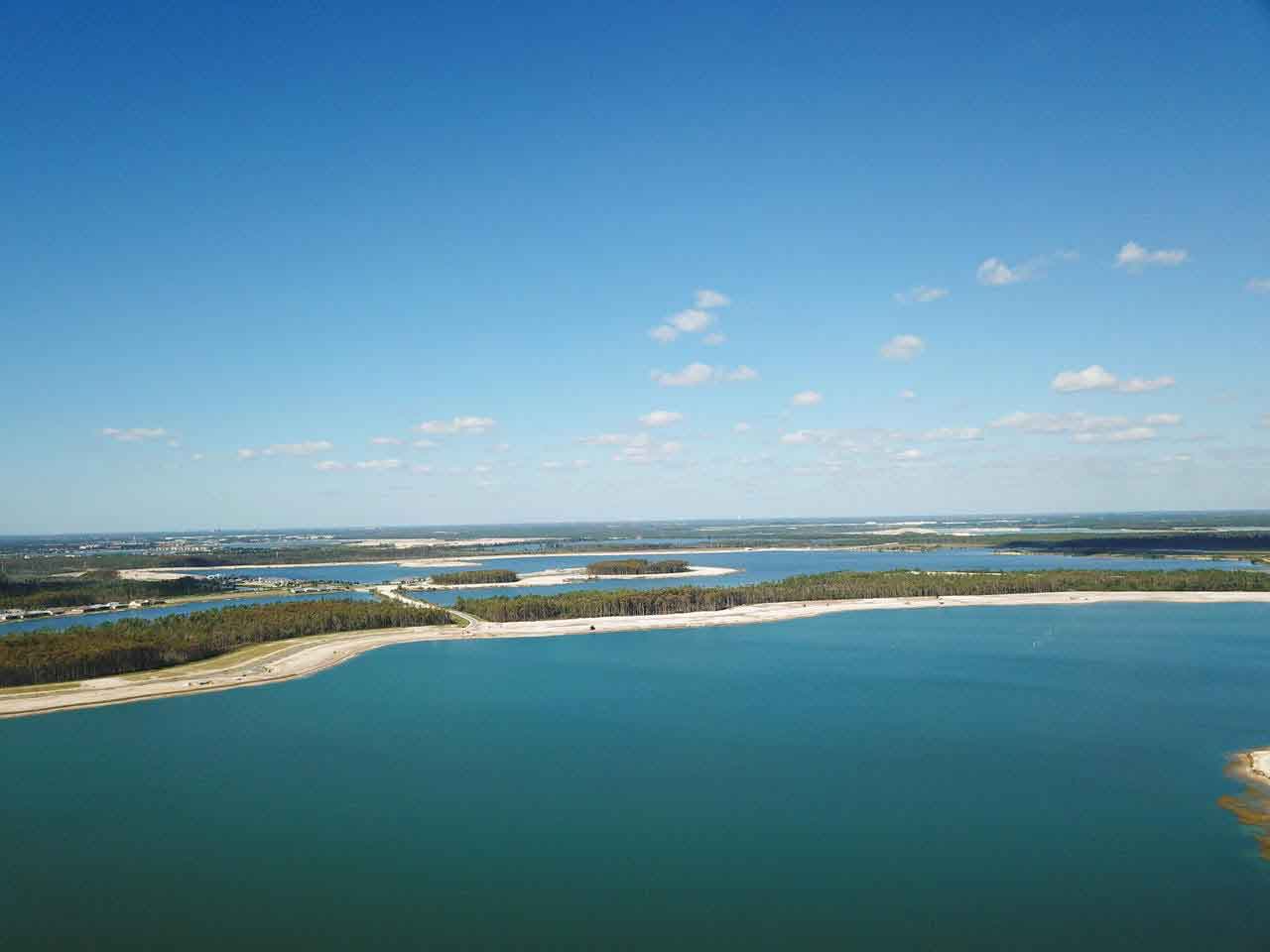 An aerial view of a large body of water surrounded by trees.