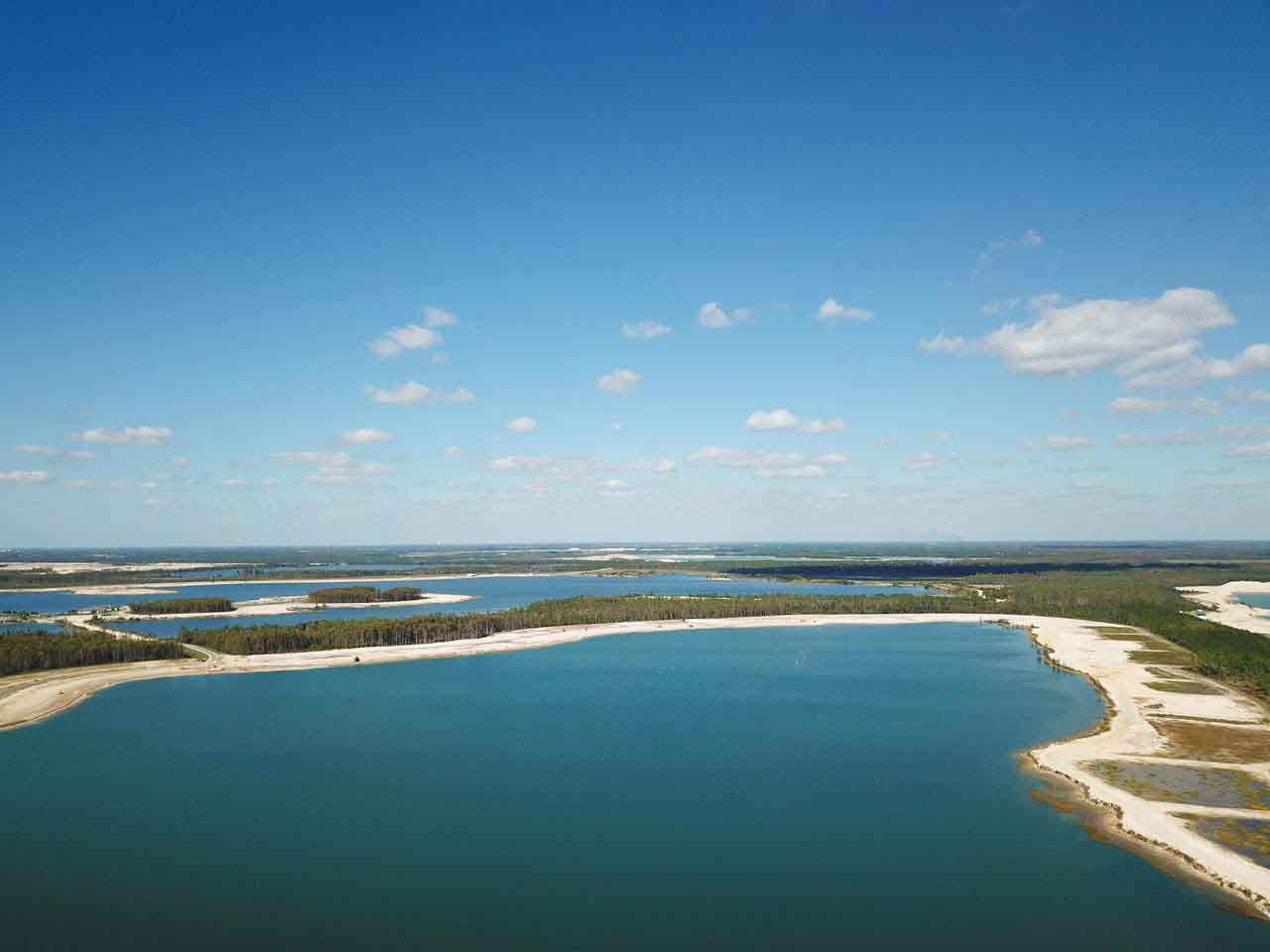 An aerial view of a large body of water surrounded by trees.