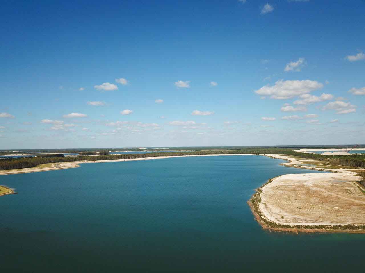 An aerial view of a large body of water with a small island in the middle.