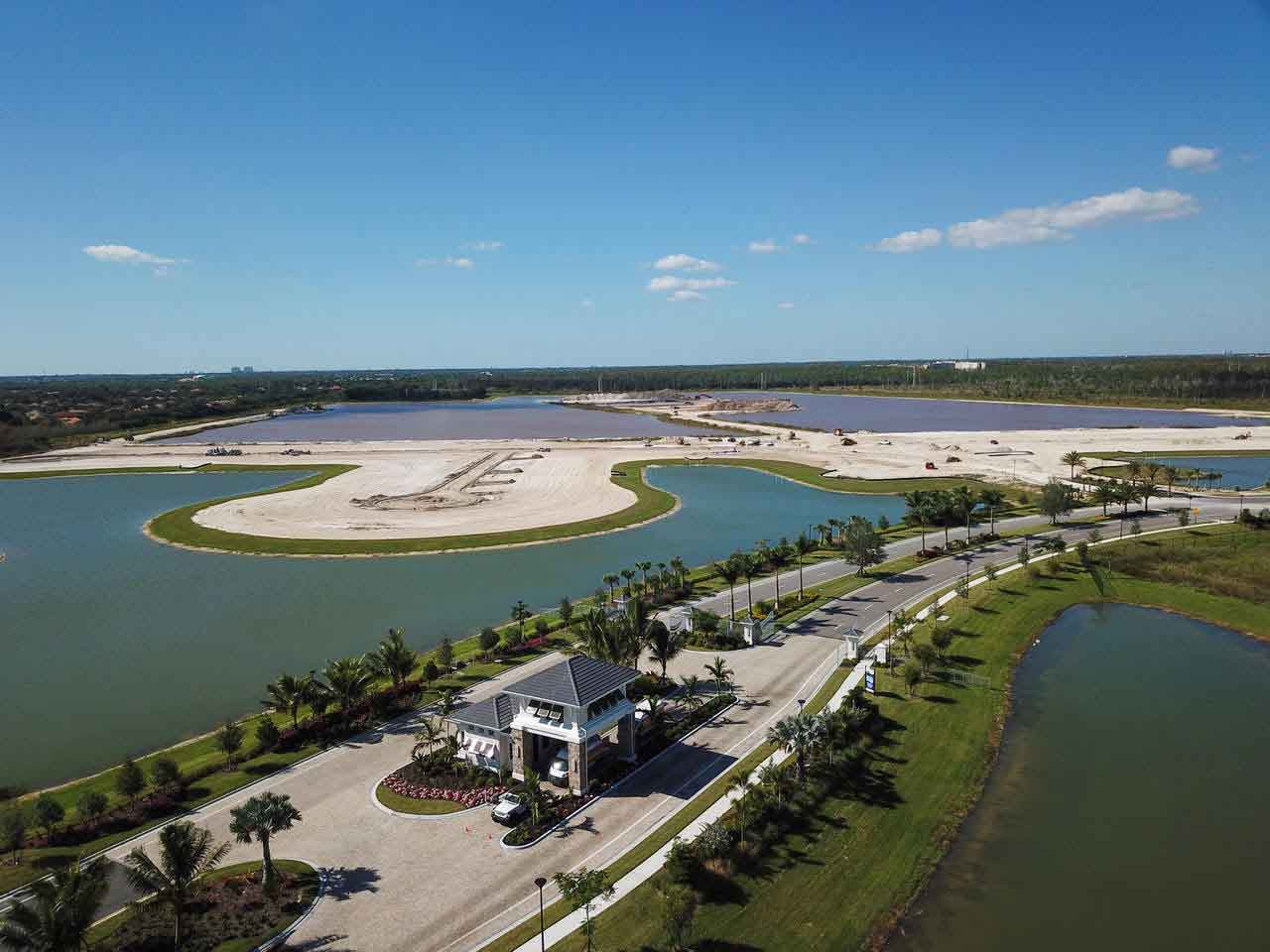 An aerial view of a lake with a house in the middle of it.