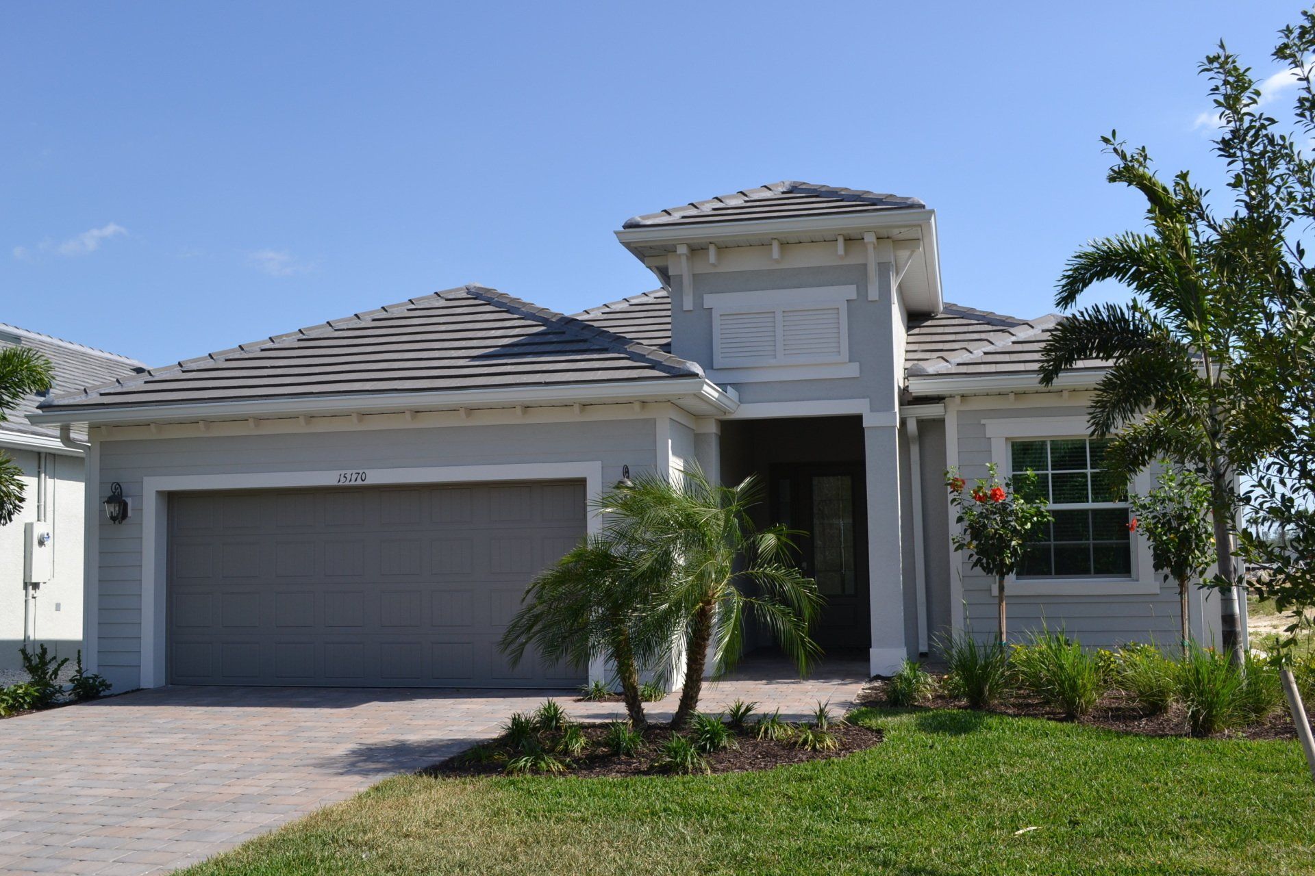 The front of a house with a gray garage door