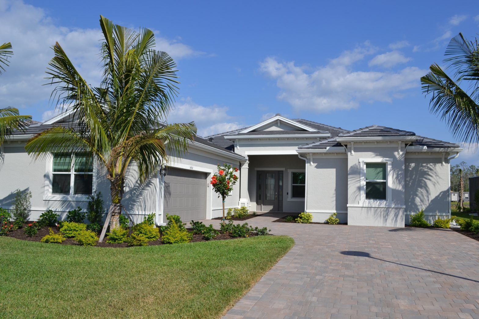 A white house with palm trees in front of it