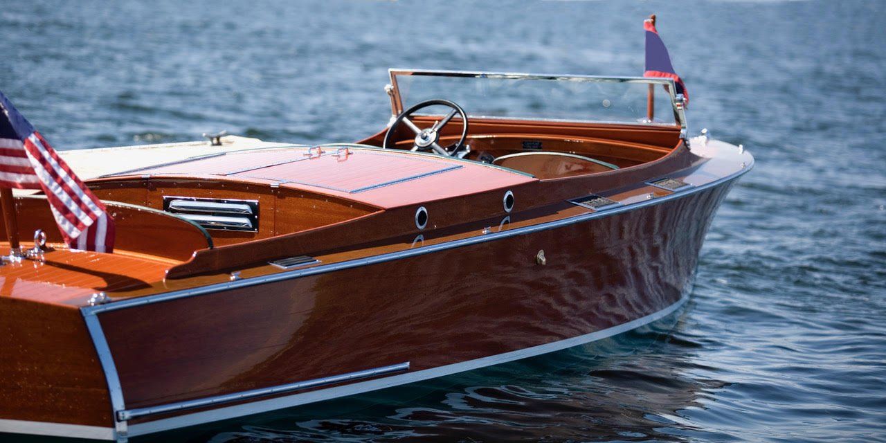 A small wooden boat is floating on top of a body of water.