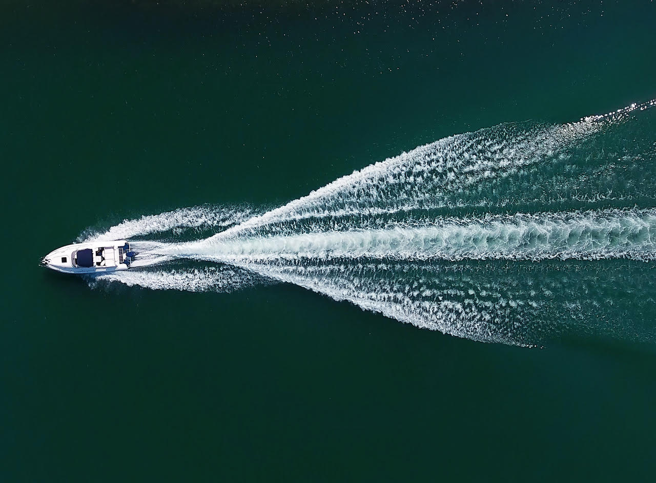 An aerial view of a boat floating on top of a body of water.