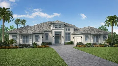 A large white house with a gray roof and palm trees in front of it.