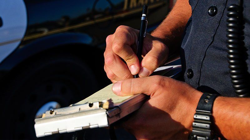 police officer writing in his notepad