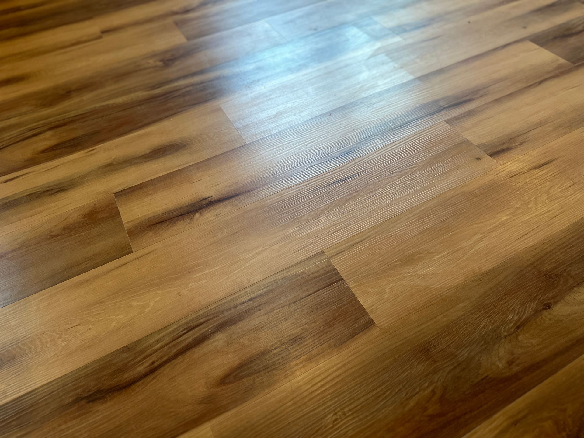 Modern living room with luxury vinyl plank flooring showcasing wood-look design and durability.