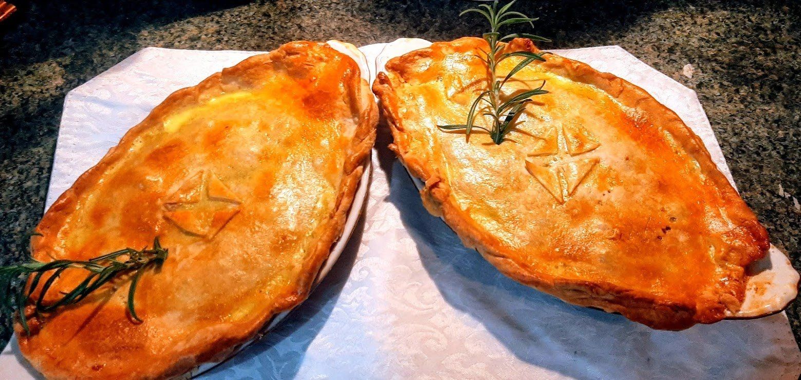 Two pies are sitting on a piece of paper on a table.
