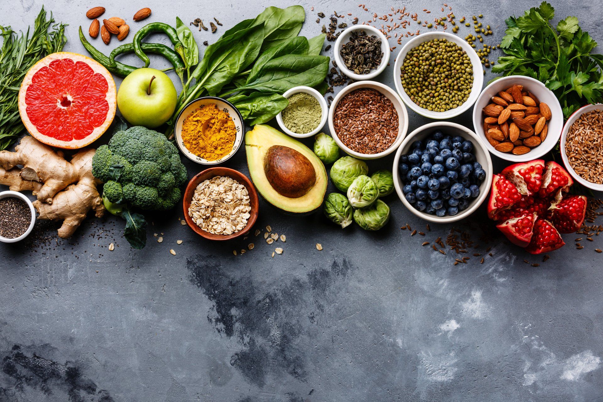 There are many different types of fruits and vegetables on the table.