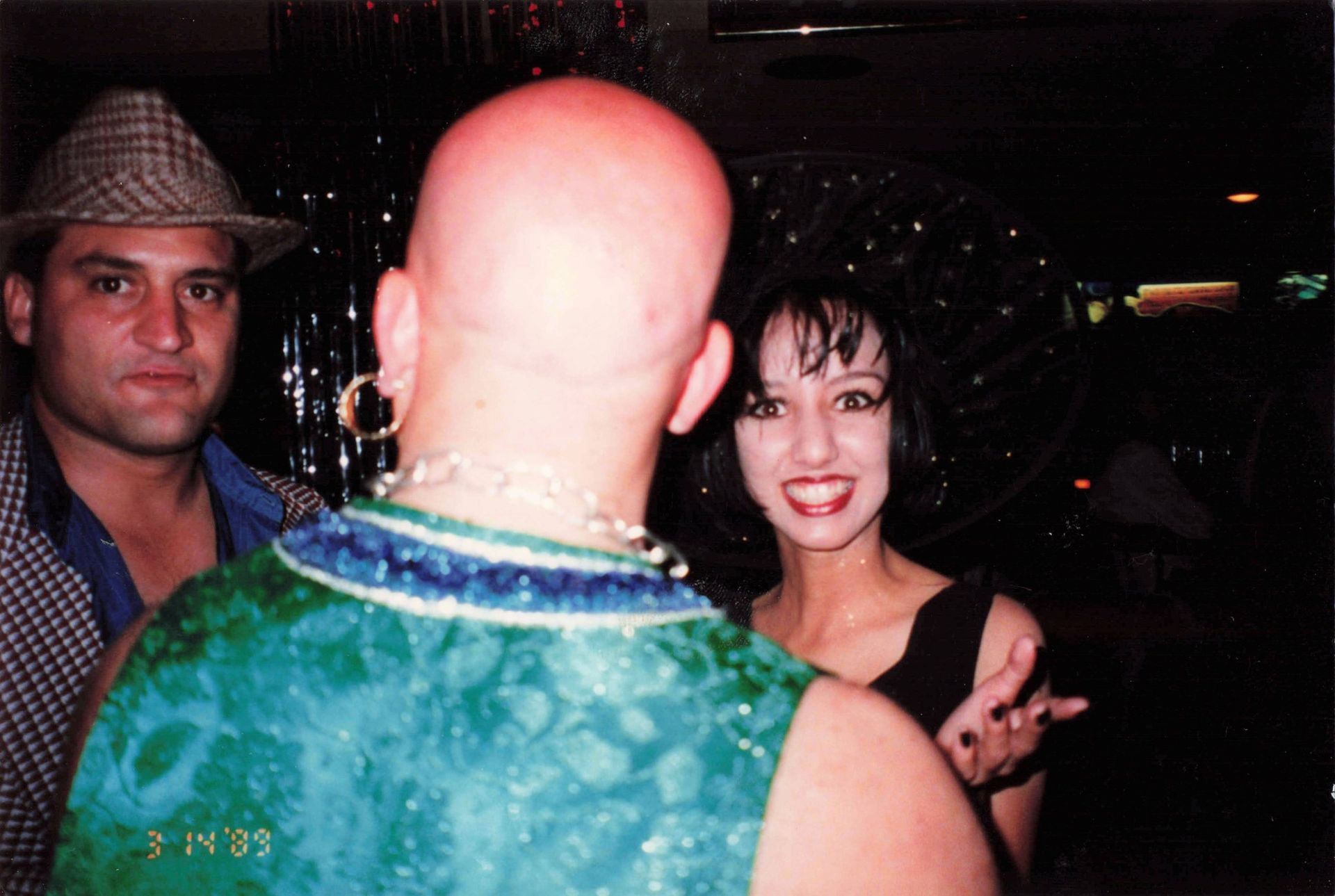 A bald man and a woman are standing next to each other