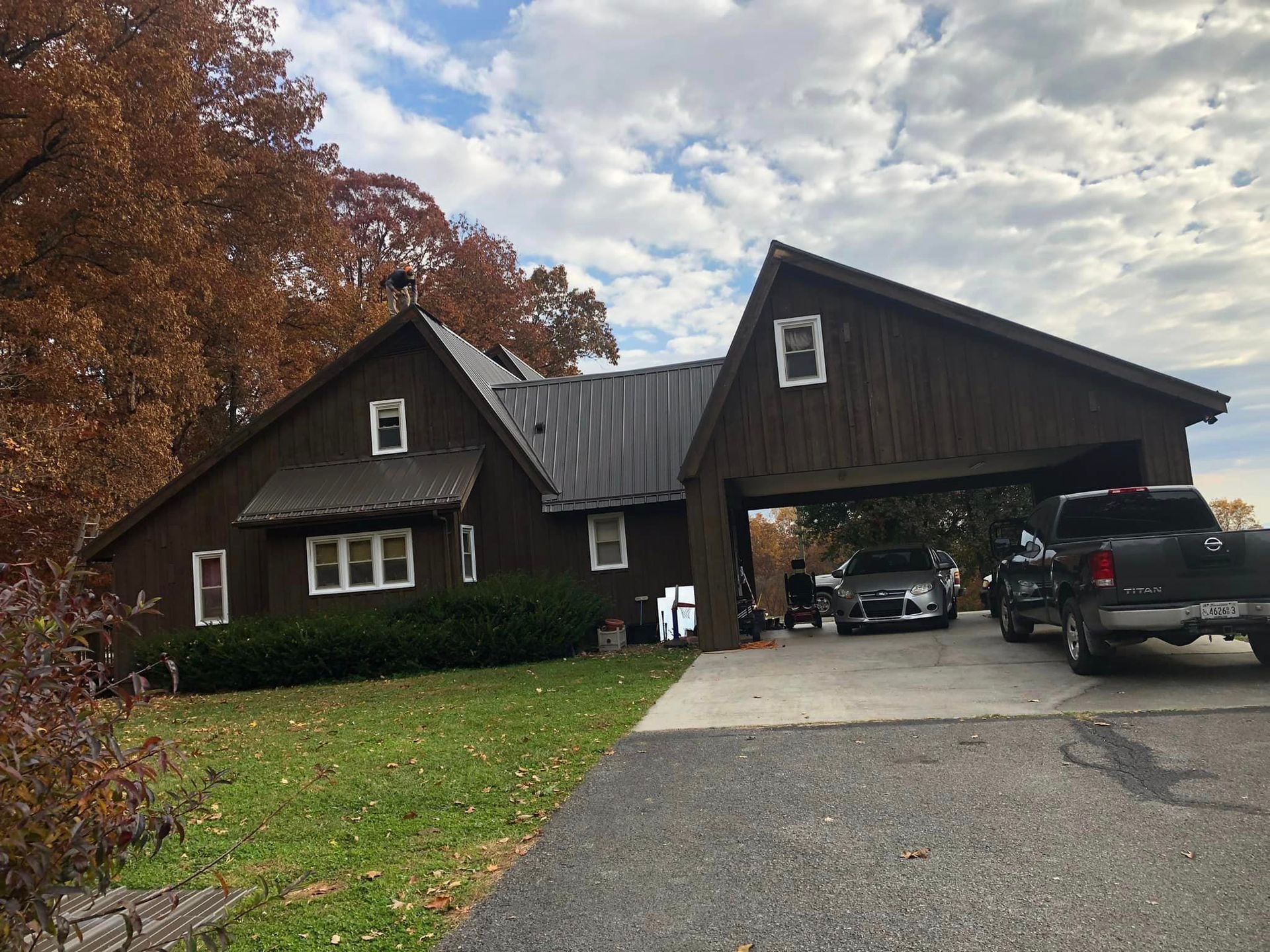 A truck is parked in front of a house with a garage.