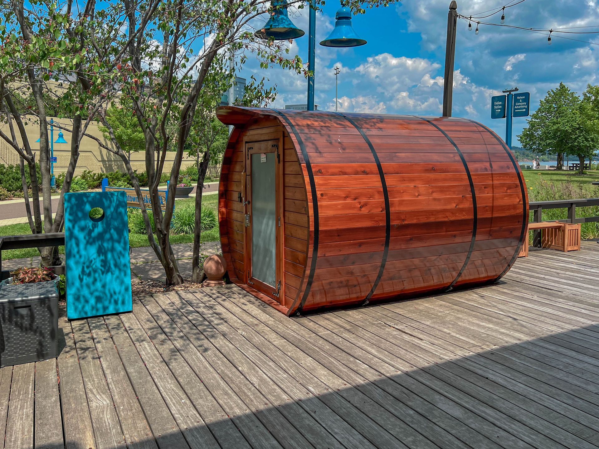 A wooden barrel is sitting on a wooden deck.