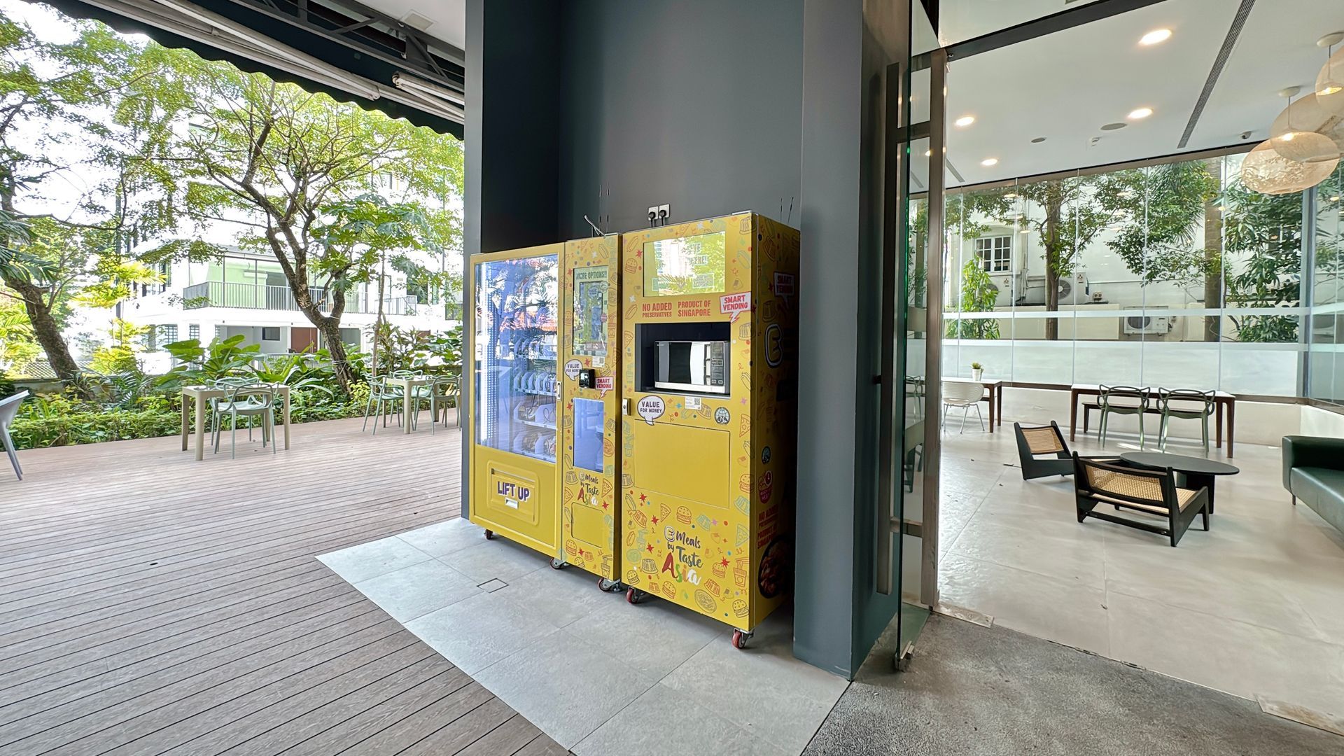 Yellow vending machines outside, next to an open door to a seating area.