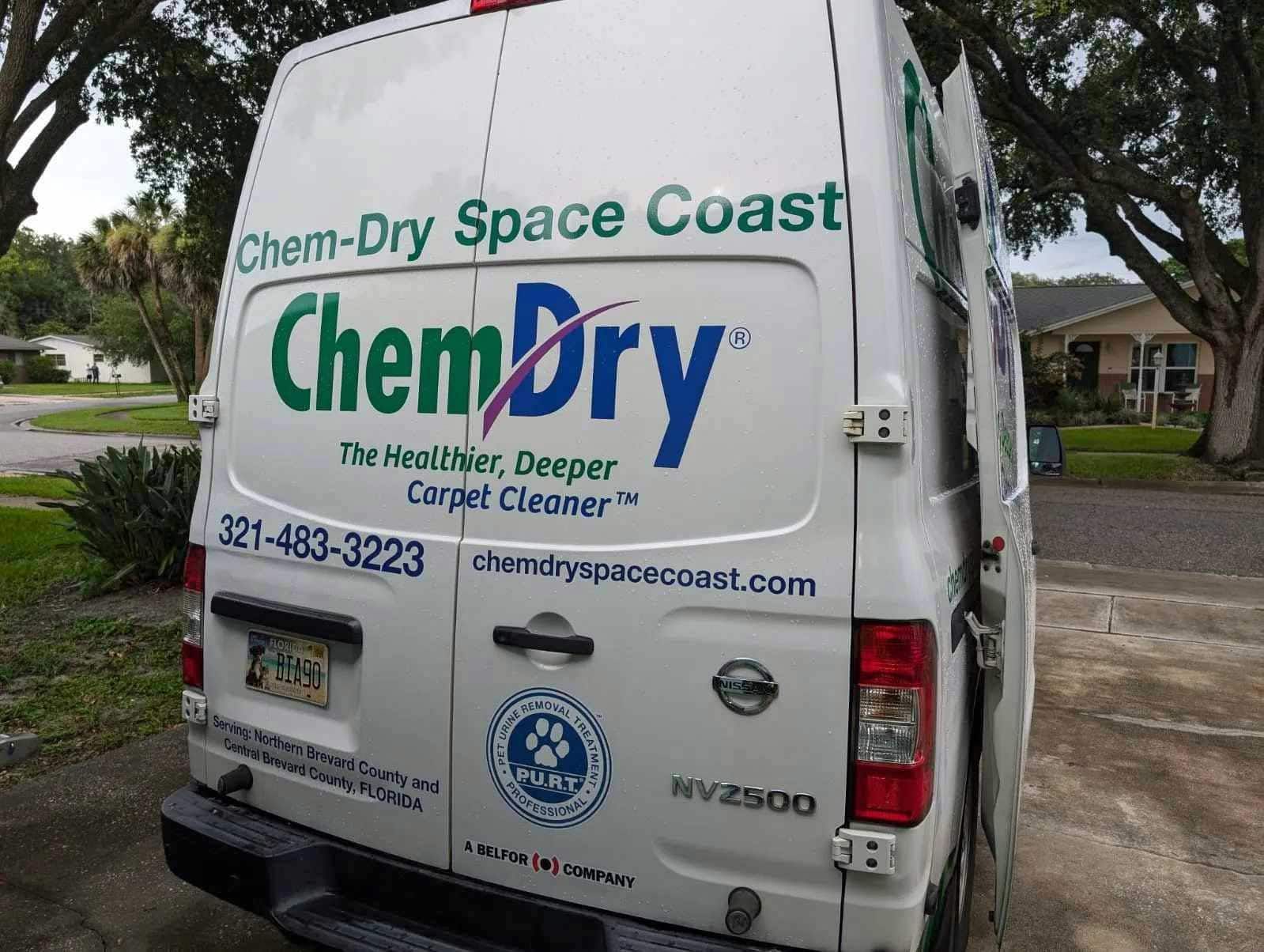 A Chem-Dry van with logo parked outdoors.