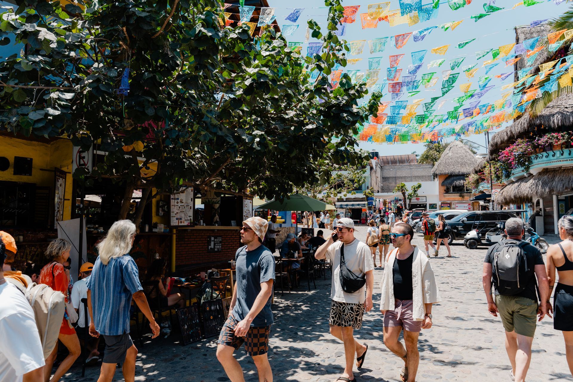 A group of people are walking down a street.