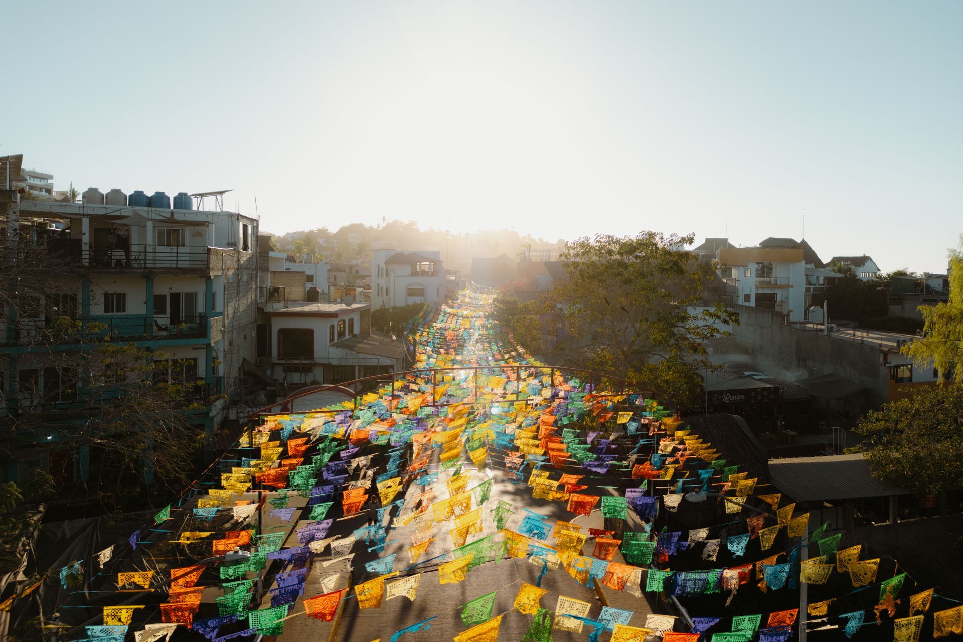 An aerial view of a street filled with colorful flags.