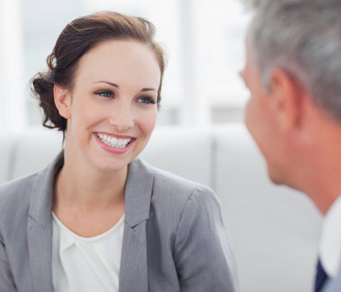 Cheerful Businesswoman Talking to Her Workmate — Insurance in Port Orange, FL