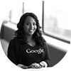 A black and white photo of a woman wearing a google shirt.