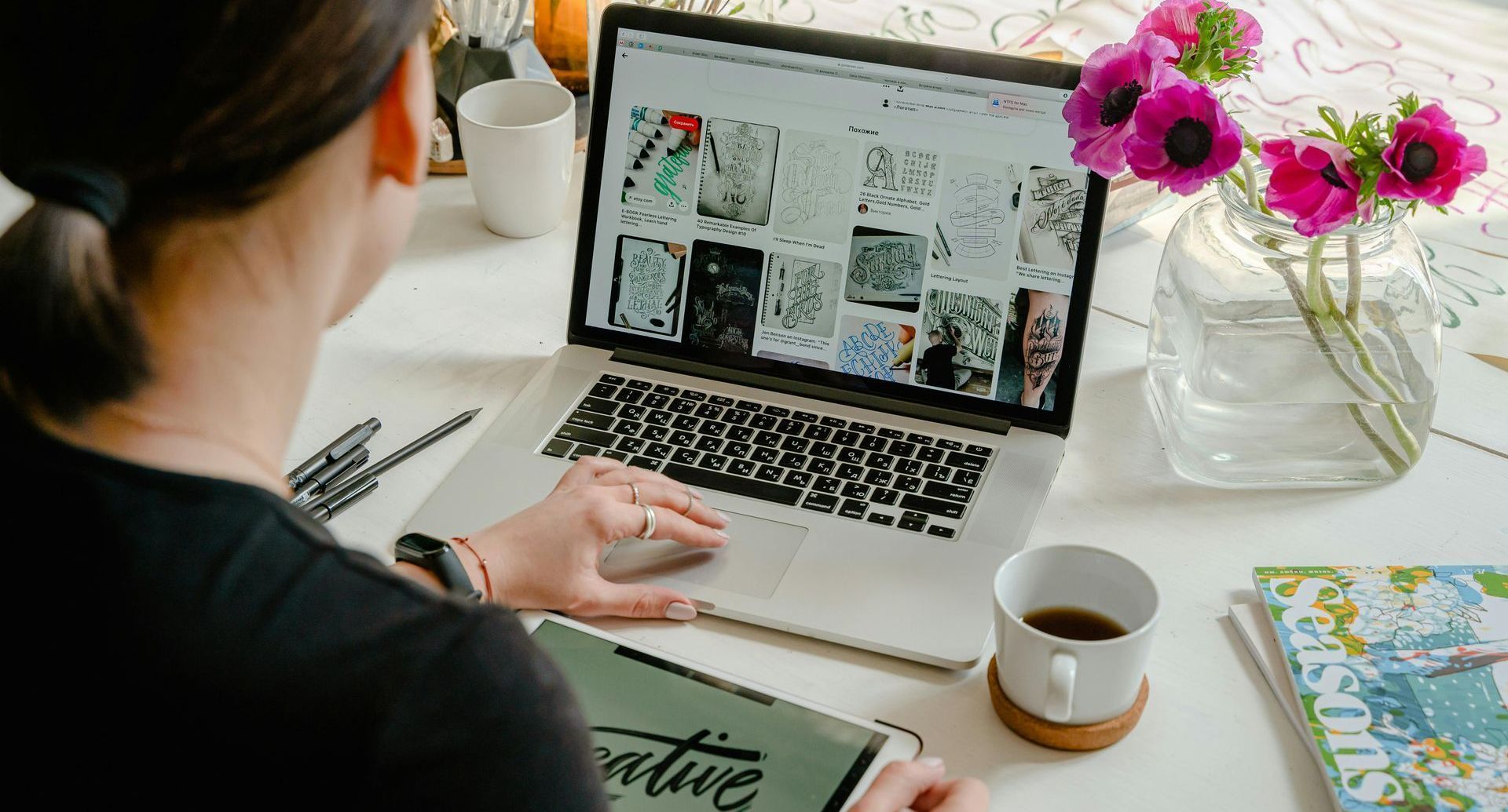 A woman is sitting on a couch using a laptop computer.