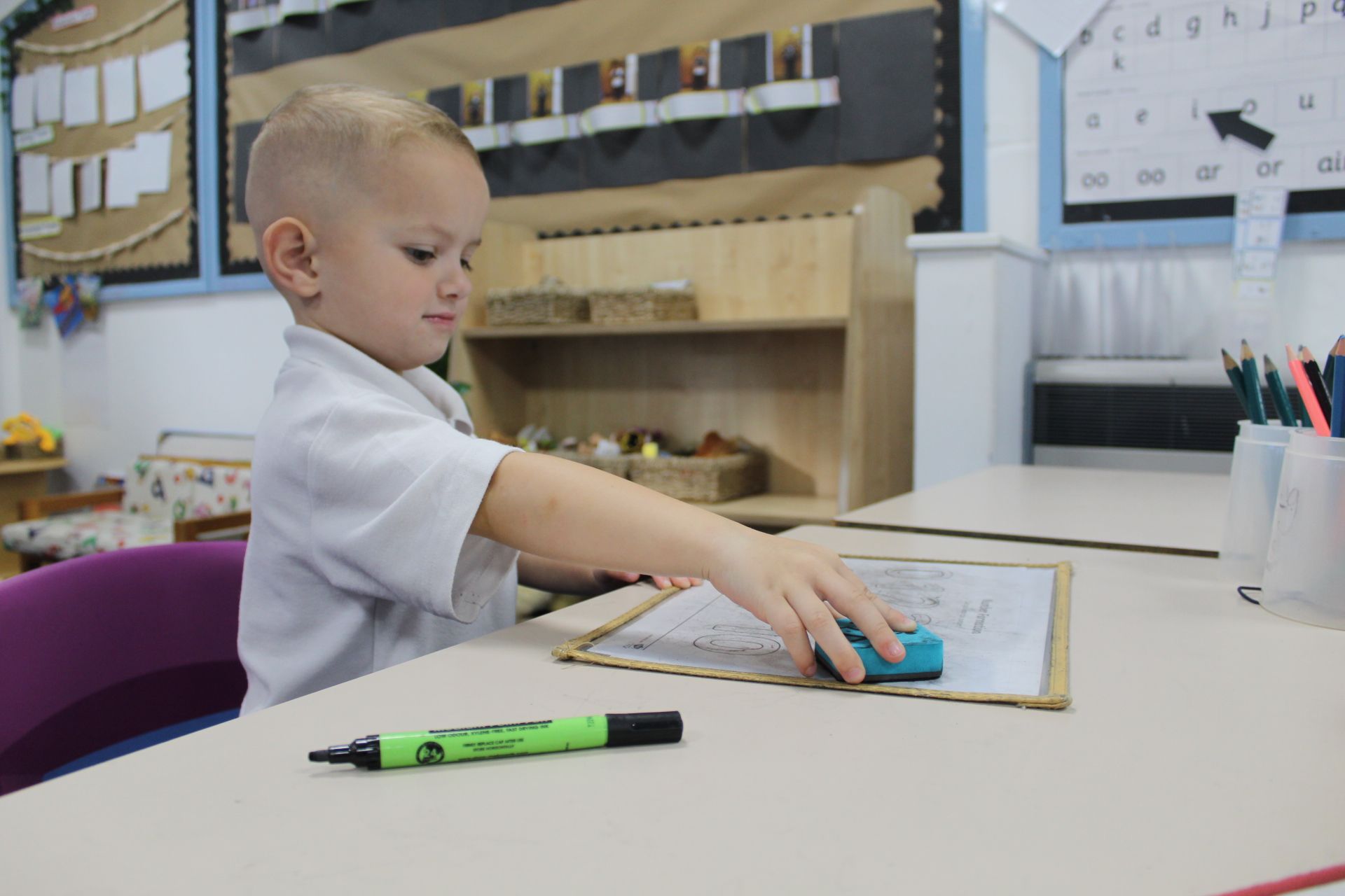 Colorful chalk sticks arranged in a layered cluster on a dark surface.