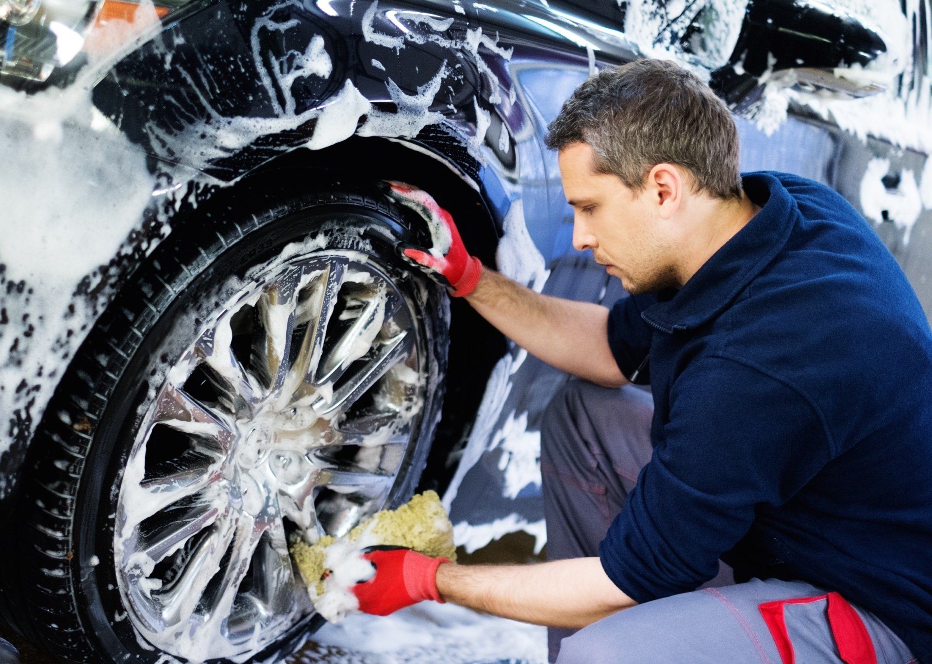 A worker cleaning a tire
