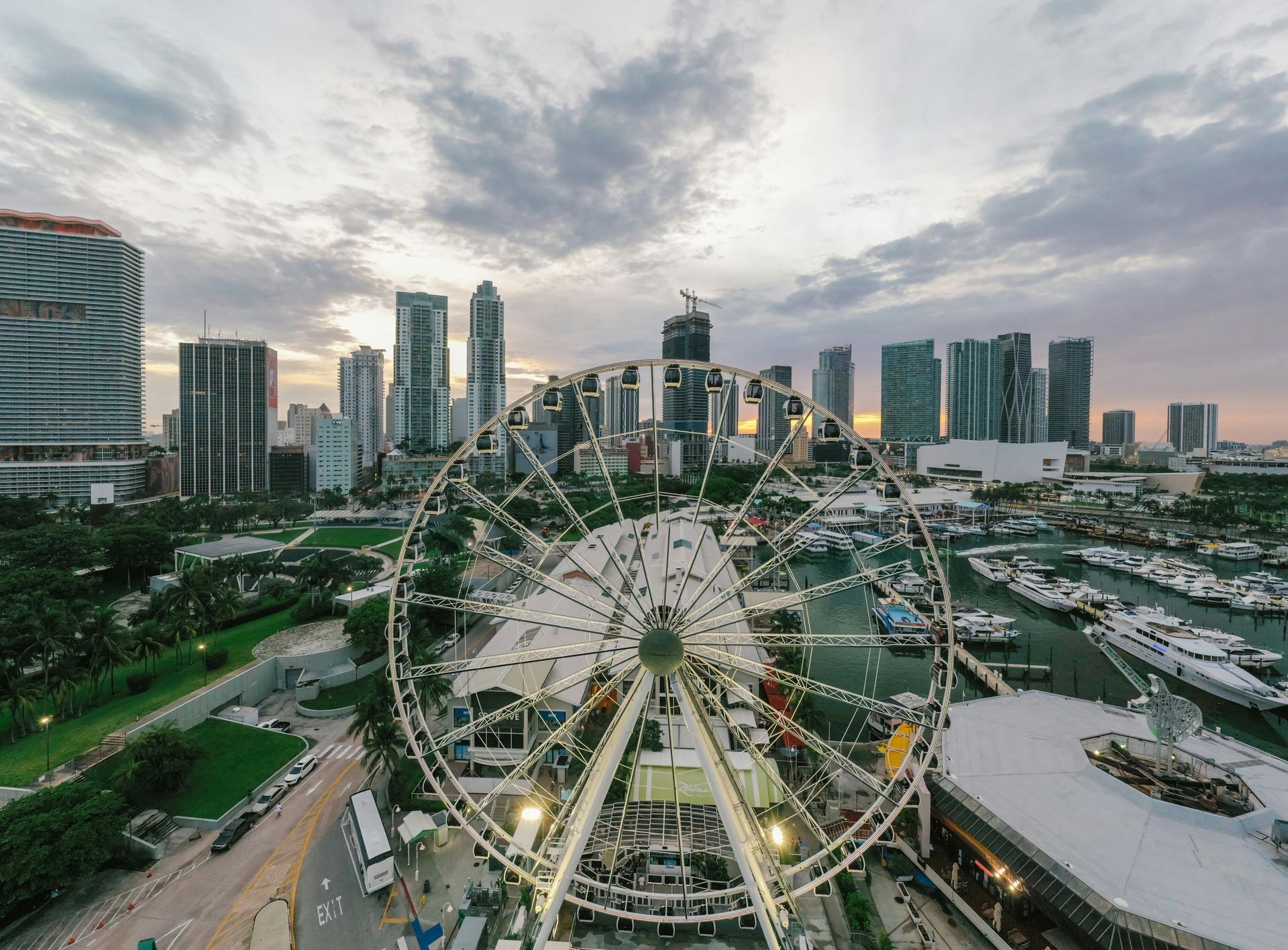 An aerial view of a ferris wheel in the middle of a city.