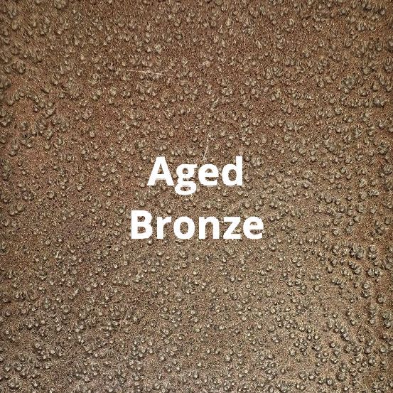 A close up of a brown surface with the words aged bronze written on it