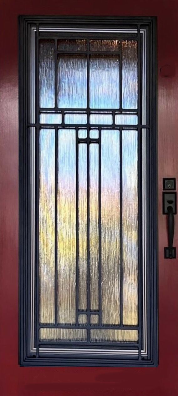 A door with a stained glass window and a metal frame.