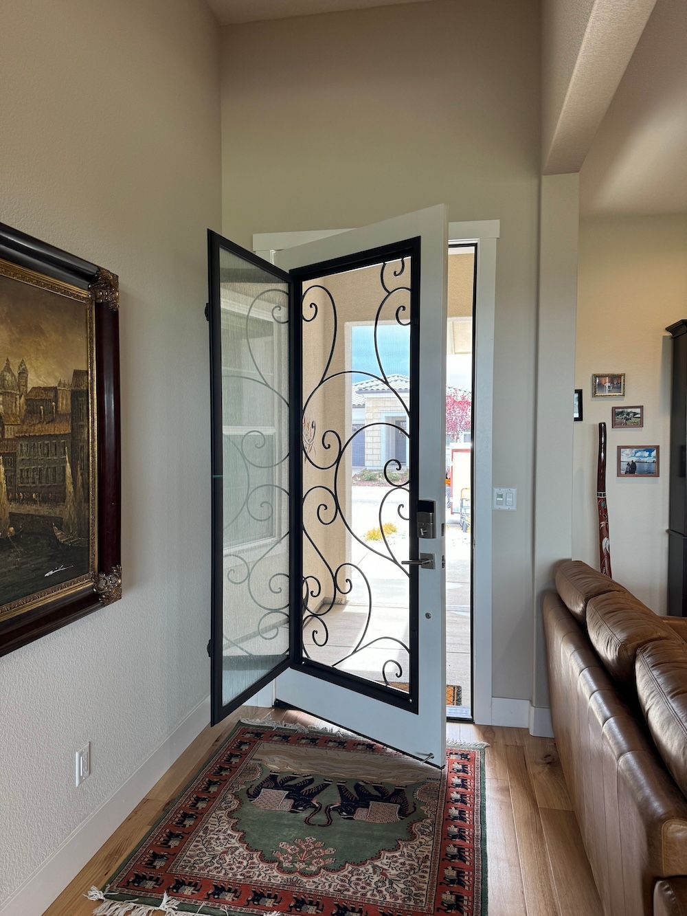 A living room with a couch and a door that is open