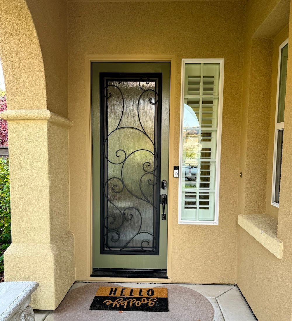 The front door of a house has a welcome mat on the floor