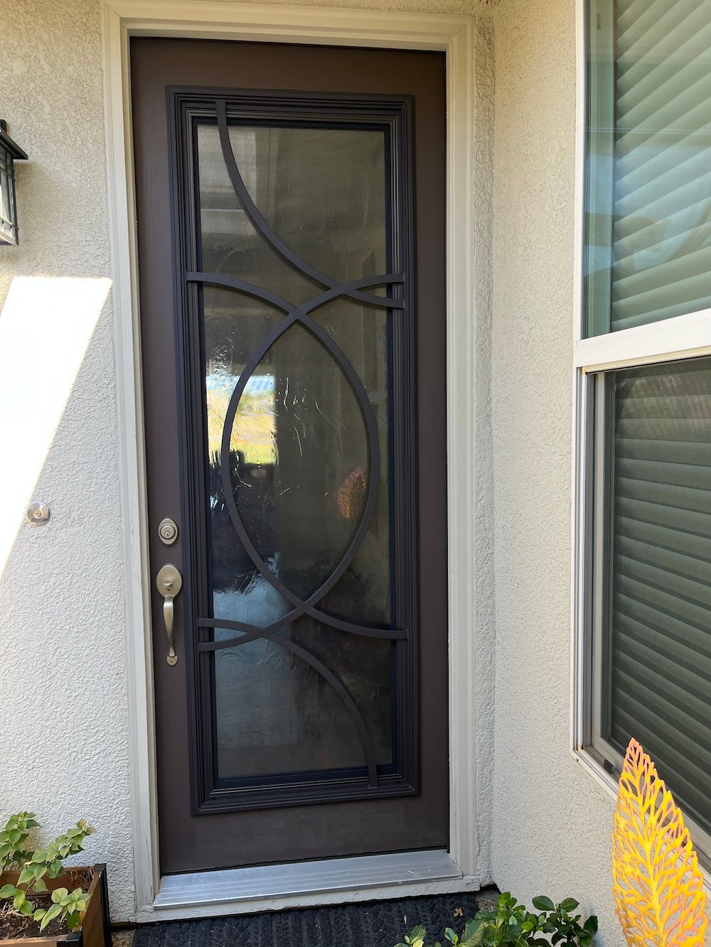 A brown door with a wrought iron design on it