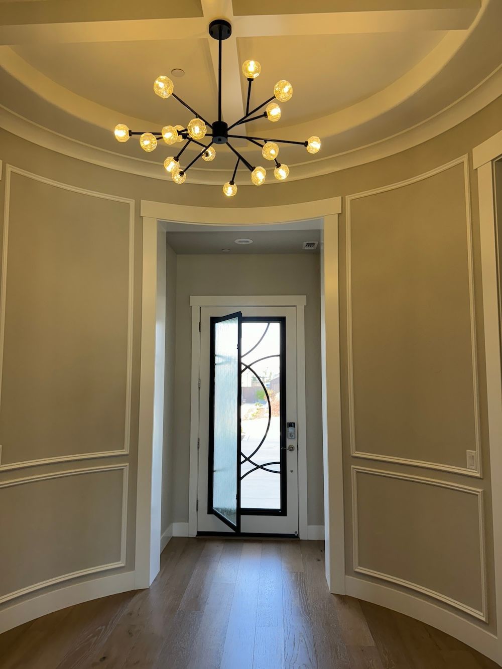 An empty hallway with a chandelier hanging from the ceiling