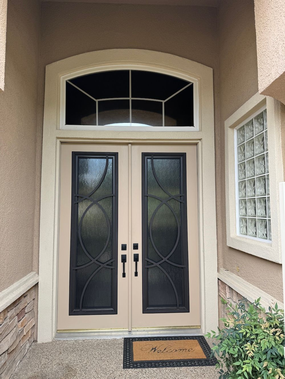 A door with a welcome mat in front of it